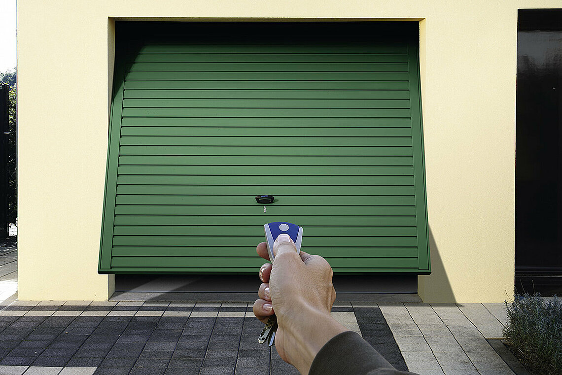 steel up and over garage door with green color finish