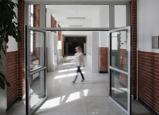 fire resistant door with integrated hold open mechanism for barrier-free mobility